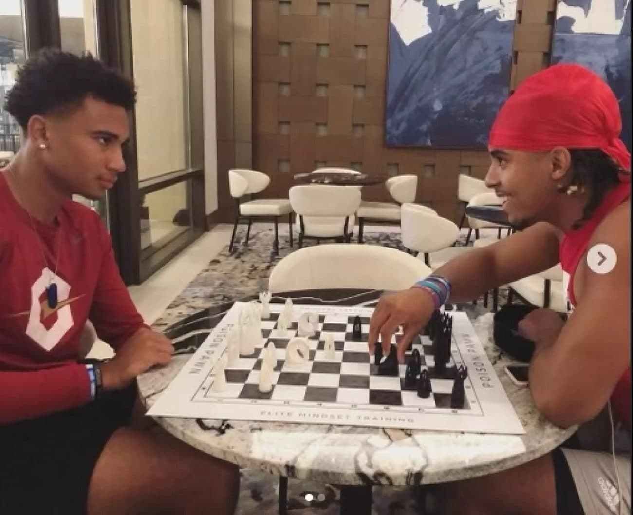 C.J. Stroud and Gee Scott Jr. playing chess on a Poison Pawn board.